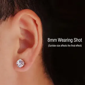 Macro view of minimalist 8mm silver stud earring with clear round sparkling gemstone