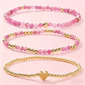 Juego de pulseras apilables de cristal rosa y cuentas doradas con dije de corazón