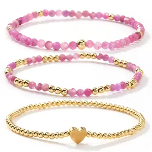 Elegante conjunto de pulseras de cristal rosa y cuentas doradas con dije de corazón