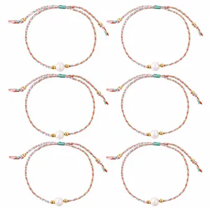 Set of six handmade braided colorful string bracelets with central pearls and gold beads
