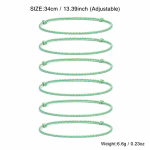 Detailed view of adjustable handmade braided rope bracelets with blue and yellow stripes.