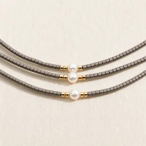 Handmade minimalist geometric grey bead bracelet featuring a central elegant white pearl