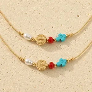 Handcrafted braided cord bracelet with pearl, gold medallion, and turquoise cross