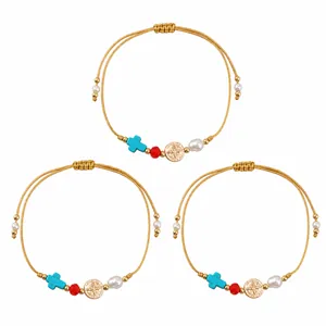 Hand-woven gold cord bracelets with decorative pearls and turquoise cross beads.