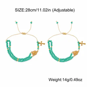 Adjustable blue beaded bracelet with gold cross and coin charms, total length 28cm