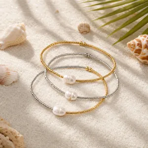 Minimalist summer beaded bracelets for women featuring elegant white pearls on sand