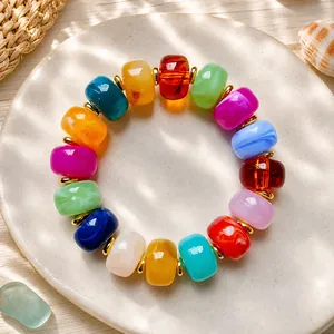 Vibrant multi-colored resin barrel bead bracelet with 15mm beads for summer fashion.