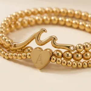 Ensemble de bracelets dorés à perles avec breloques cœur lettre A et vague