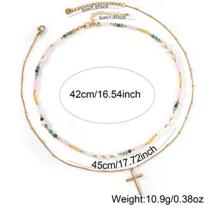 Layered colorful beaded necklace with white pearls and a gold-plated cross pendant