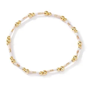 Elegant Bohemian bracelet featuring gold copper beads and cream-colored seed beads.