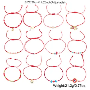 Set of 12 adjustable red string bracelets featuring evil eye and gold heart charms