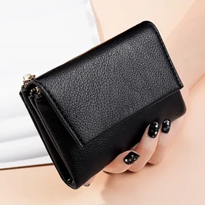 Close-up of black pebbled leather wallet detail showing texture and side view.