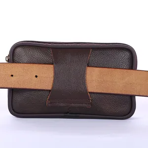 Macro detail of the sturdy back belt loop on this brown pebbled leather men's waist bag