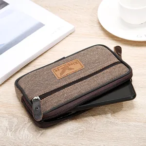 Close-up of the durable men's canvas phone pouch with three zippers showing smartphone fit.