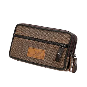 Close-up of brown canvas men's phone waist bag with three zipper compartments