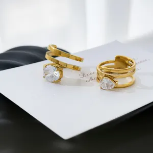 Close-up of gold-plated titanium steel rings with oval and pear-shaped zirconia stones