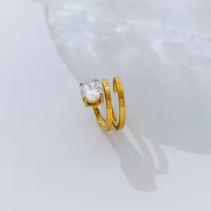 Close-up of a multi-layer 18K gold plated ring with a clear oval zircon stone.