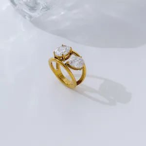 Macro detail of a 18K gold-plated double band ring with pear and oval cubic zirconia