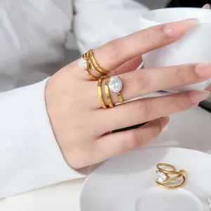 Close-up detail of 18K gold plated multi-layer rings with elegant teardrop cubic zirconia stones