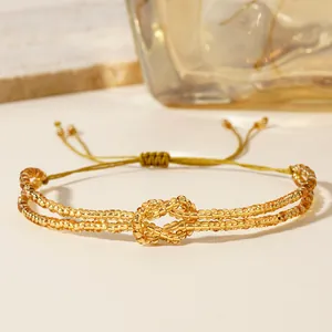Handmade golden seed bead infinity knot bracelet with adjustable cord closure system
