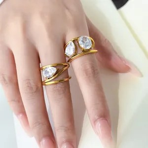 Detail of 18K gold plated multi-layer rings featuring teardrop and oval zircon stones