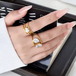 Detail view of gold plated multi-layer rings with sparkling pear and oval cut zircons.