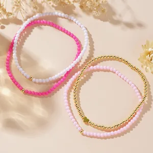 Elegante set 4 cavigliere con perline dorate, acrilico rosa bianco e ciondolo a cuore donna