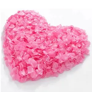 Pink artificial rose silk petals arranged in a large heart shape for wedding decor