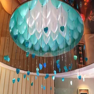 Close-up view of shiny laser heart-shaped PVC sequin pendants hanging from decorative balloons