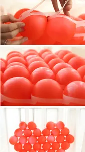 Detail showing red 5 inch latex balloons being placed into a heart-shaped grid for decoration