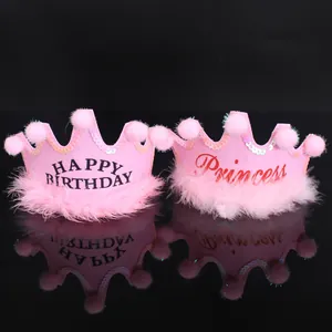 Detailed view of pink princess birthday crown hats with sequins and pom-poms