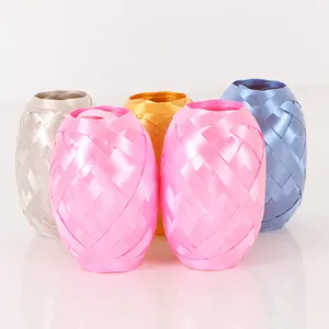 Close-up of multi-colored football-shaped ribbon rolls for festive wedding decorations