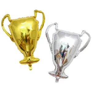 Detailed view of gold and silver trophy-shaped foil balloons for party decoration