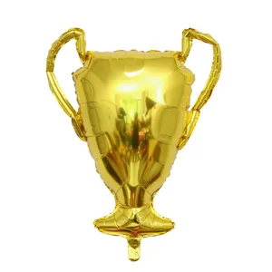 Detail of a shiny golden trophy-shaped foil balloon for victory and party celebration