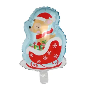 Detalle de un globo navideño de papel de aluminio con un reno en un trineo sobre fondo blanco