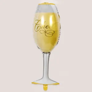 Detail of a champagne glass foil balloon featuring a gold 'Cheers' printed design.