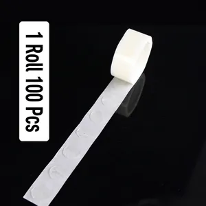 Close-up of double-sided transparent adhesive dots on a roll for balloon decoration