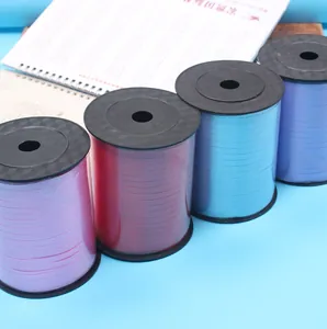 Close-up view of four vibrant 500-yard ribbon rolls for DIY wedding and party decorations