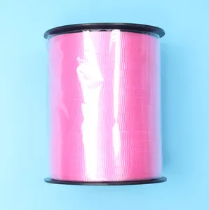 Detailed view of 500 yards pink decorative ribbon roll for DIY wedding projects.