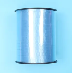 Large spool of shiny light blue decorative ribbon for balloons and DIY crafts