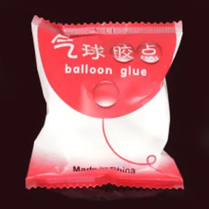 Close-up of red and white balloon glue dots packaging for wedding party decoration