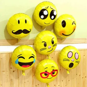 Various yellow emoji foil balloons arranged for party decoration scene details