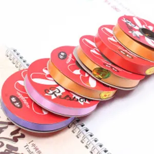 Macro view of multiple colorful rolls of shiny decorative ribbon for balloons and gift wrapping