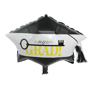 Detail view of a black graduation cap shaped foil balloon with Congrats GRAD text.