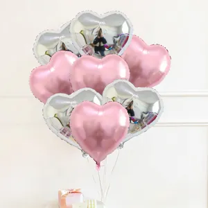 Bunch of 22-inch heart-shaped foil balloons in pink and silver for wedding decorations