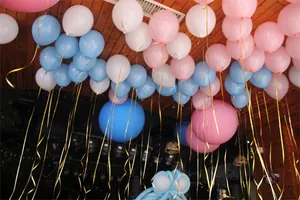 Shining gold laser ribbon strings hanging from colorful balloons for party decor