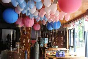 Party scene showing rose gold laser balloon ribbons tied to colorful balloons in a room.