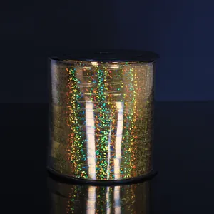 Detail of golden holographic laser ribbon roll for balloon decoration and weddings