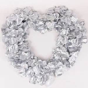 Heart-shaped arrangement of silver artificial rose petals for wedding decoration