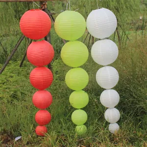 Decorative round paper lanterns in red, green, and white colors with assorted sizes.